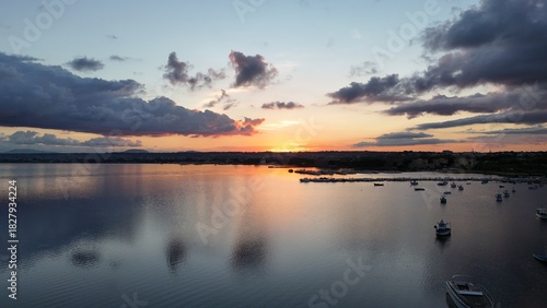 Fototapeta Naklejka Na Ścianę i Meble -  Insanely beautiful drone photography of a scenic sunrise, early in the morning, by the salt marshes in Marsala, Sicily, during a lovely morning.	