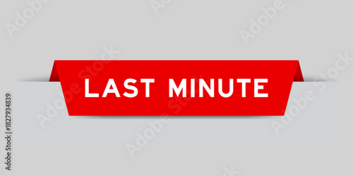 Red color inserted label with word last minute on gray background