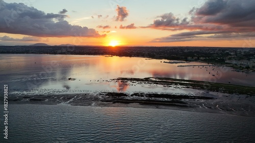 Fototapeta Naklejka Na Ścianę i Meble -  Insanely beautiful drone photography of a scenic sunrise, early in the morning, by the salt marshes in Marsala, Sicily, during a lovely morning.	