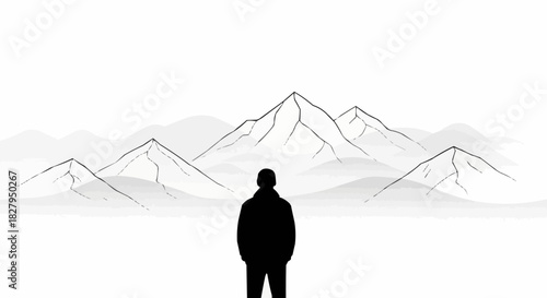 Silhouette of a person standing before majestic mountain peaks contemplating nature.