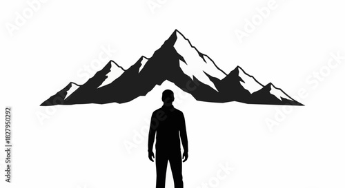 Silhouette of a person standing in front of majestic mountains.