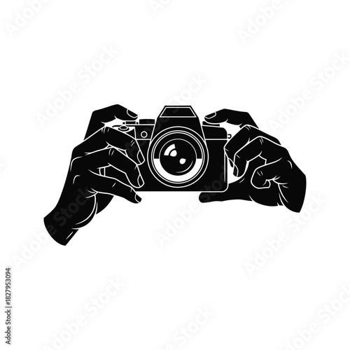 Black silhouette of hands holding a vintage camera capturing a moment isolated on white background