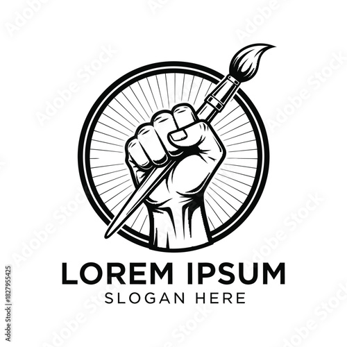Fist holding paintbrush inside a circle with radiating lines symbolizing art and creativity