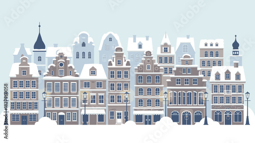 A charming row of snow-covered European-style buildings with intricate architectural details under a pale blue sky.