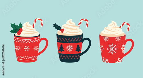 Set of three decorative red and blue Christmas mugs with hot cocoa whipped cream holly and candy canes for winter holidays.