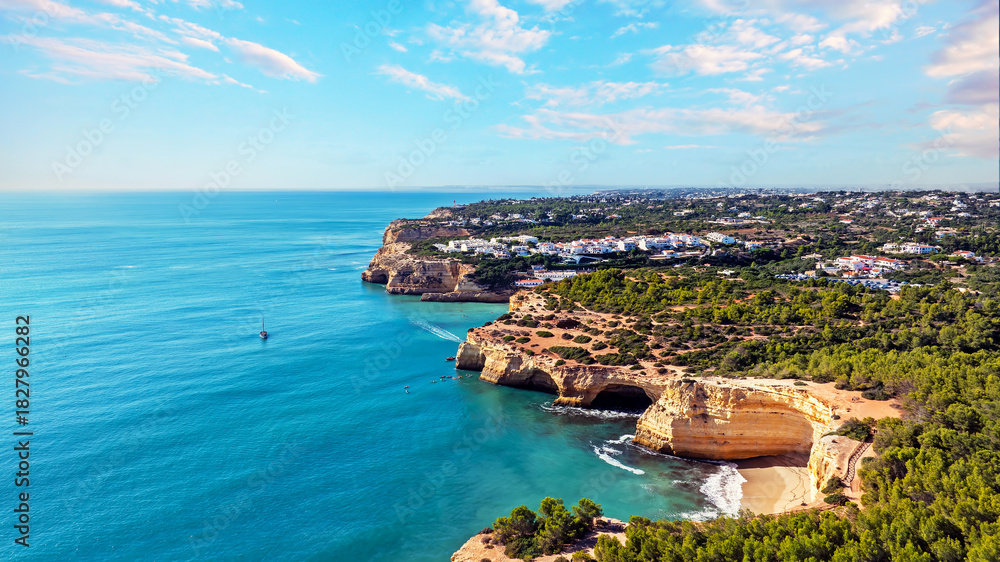 Fototapeta premium Aerial from the famous cave of Benagil and the little town Benagil on the southcoast in the Algarve Portugal