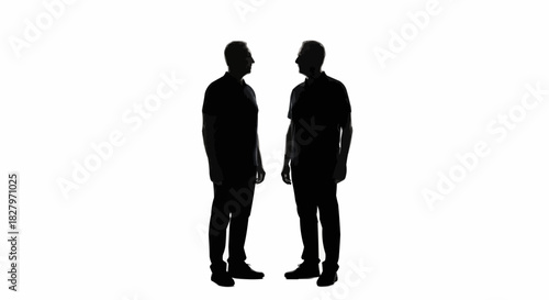 Two men standing facing each other in silhouette.