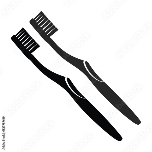 Two black toothbrushes are displayed diagonally on a plain white background