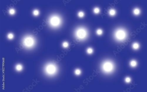 Bright white glowing particles floating across deep blue background creating magical dreamy star-like abstract atmospheric illumination pattern