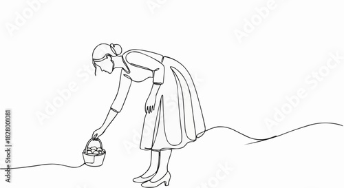 Woman in dress bending down to pick up a small basket.