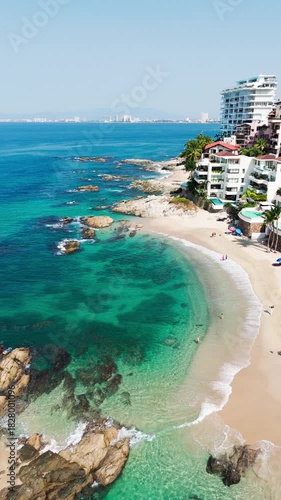 Aerial view showing tropical beach, turquoise ocean, and luxury resorts in puerto vallarta