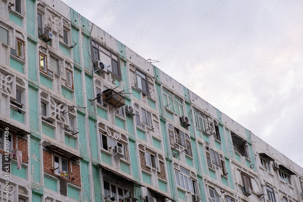 Naklejka premium High-Density Residential Building Facade with Pastel Green Trim