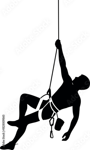 Silhouette of a rock climber suspended by a rope