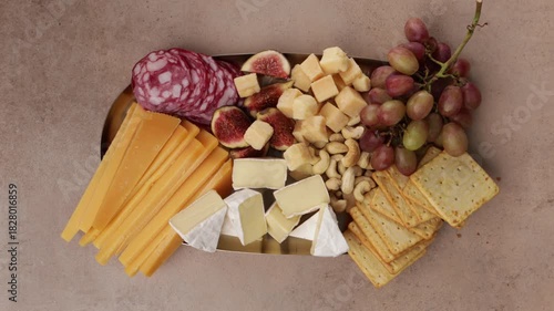 cheese slice on platter with grapes and nuts concrete top view food