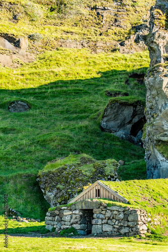 A stone shelter nestles into the hillside under Southern Iceland’s afternoon sky where tradition and nature quietly converge