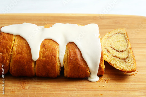 closeup of cinnamon roll loaf cake on bamboo cutting board