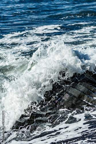Midday waves clash with basalt bones along the rugged edge of Black Beach in Southern Iceland’s volcanic embrace