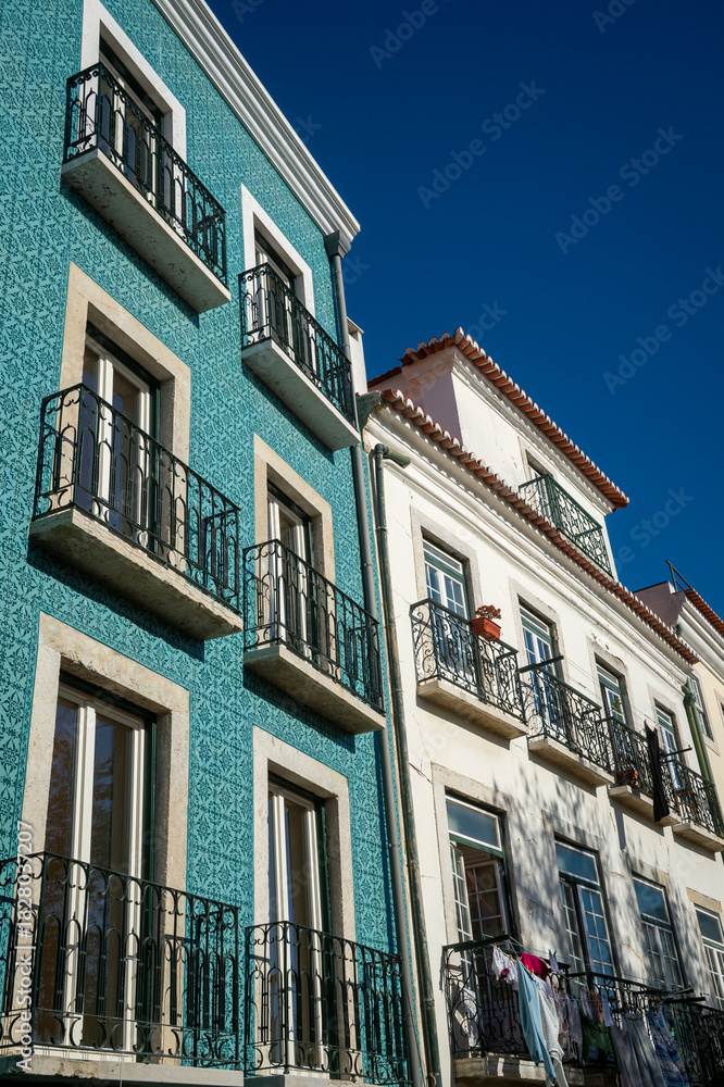 Naklejka premium View of a typical facades or a row of historic tiled buildings in Lisbon, Portugal
