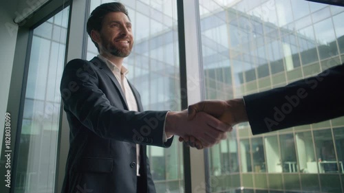 Caucasian businessman smiling business man shaking hands with African male partner in modern office handshake greeting cooperation success teamwork deal partnership agreement multicultural meeting