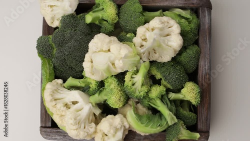 uncooked broccoli and cauliflowers florets in crate zoom food