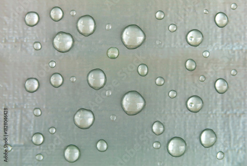 Raindrops on a silver matte background
