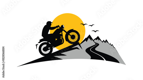 Motorcyclist silhouetted against a mountain sunset