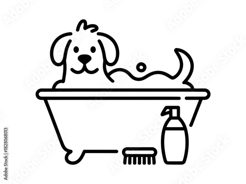 A happy dog is taking a bath in a tub with soap and a brush nearby.
