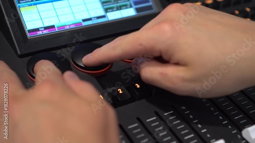 Hands of man turning shuttles on lighting mixer close up 4k