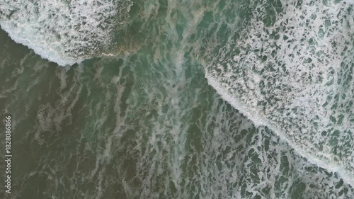 Aerial view of ocean water meeting land, United Kingdom.