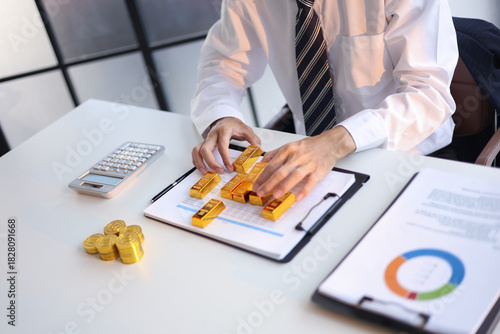 Gold Trading Businessman invest in trading gold, calculating profit price of buy and sell gold.