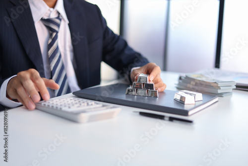 Silver Trading Businessman invest in trading silver, calculating profit price of  buying and selling silver in the market.