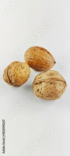 Mixed nuts on a clean white background. Walnuts, hazelnuts and peanuts in their shells, photographed as a natural snack option. Ideal for food blogs, nutrition, recipes, autumn and Chr