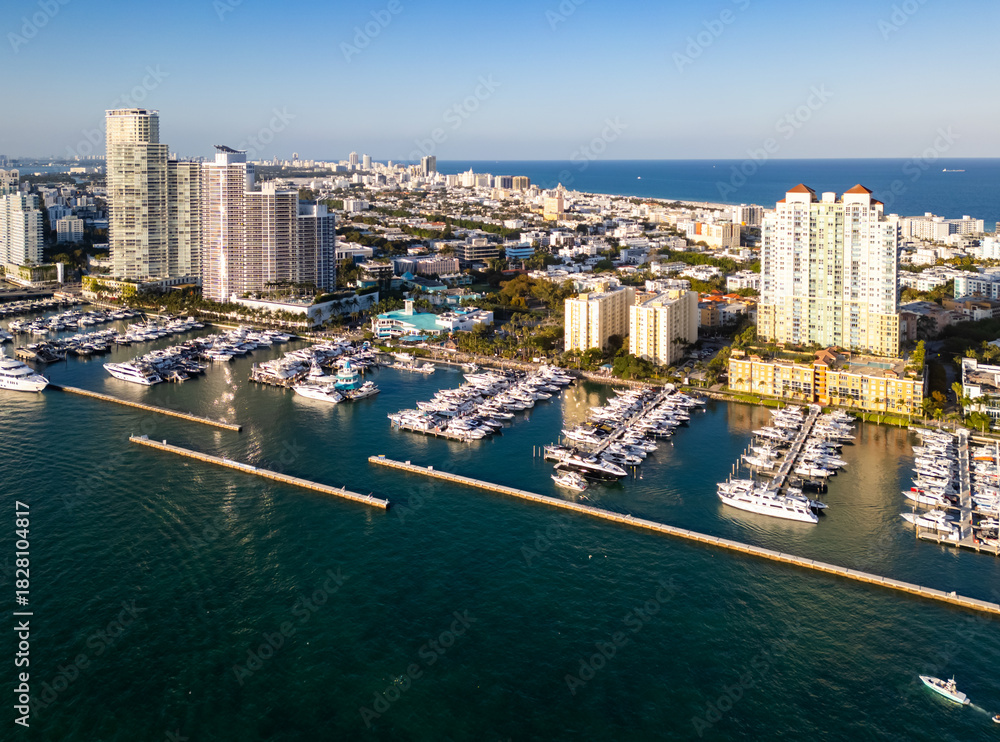 Obraz premium Miami marina with yachts and sailboats. Miami marina and turquoise ocean. Miami seascape aerial view on south beach shore. Luxury cruise ship in Miami harbor.