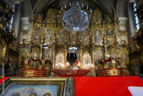 Принти на полотні Two crowns, a cup of wine and a cross prepared for baptism