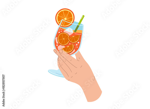 A hand holds an orange drink made from oranges