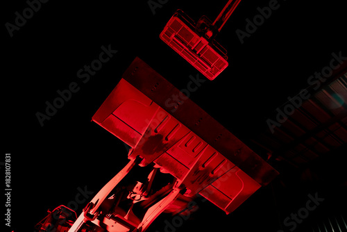 Lifted loader bucket and hydraulic arms, symbolizing the technological strain, workforce expectations, and operational challenges faced across today’s competitive construction business