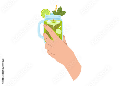 A hand holds a  green drink made from lime and mint