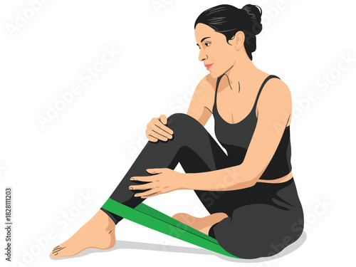 Woman in black workout clothes stretching with a green resistance band on her leg