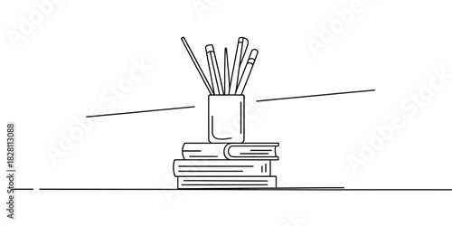 A pencil holder filled with drawing pencils sits on a stack of books.