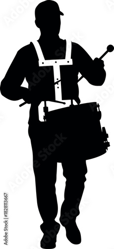 Silhouette of a marching band drummer playing percussion instrument.