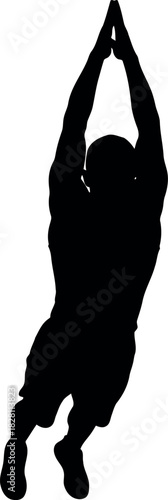 Silhouetted person reaching for goal with arms stretched upwards