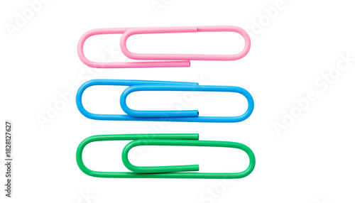 Three paper clips, one pink, one blue, and one green, are stacked vertically on top of each other in a row. no background