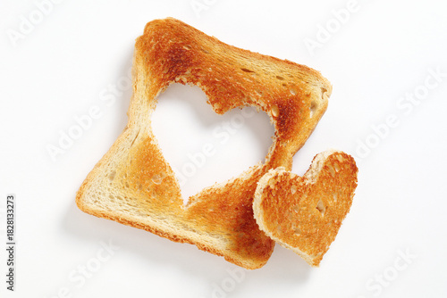 Toasted bread with cut out heart-shaped slice