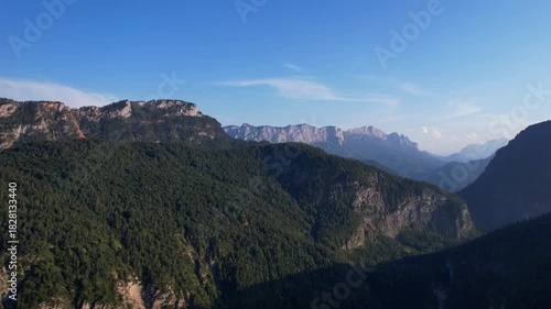 4K Aerial Drone video of Alpine lake Thumsee with turquoise water and lush green woods surrounded by tall mountains at sunset golden hour in Bad Reichenhall Germany