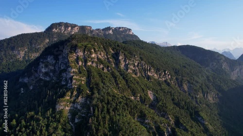 4K Aerial Drone video of Alpine lake Thumsee with turquoise water and lush green woods surrounded by tall mountains at sunset golden hour in Bad Reichenhall Germany