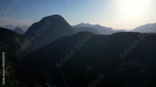 4K Aerial Drone video of Alpine lake Thumsee with turquoise water and lush green woods surrounded by tall mountains at sunset golden hour in Bad Reichenhall Germany