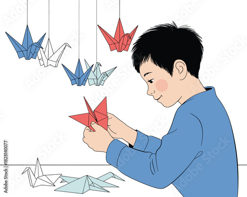 A young boy happily makes origami cranes in his room