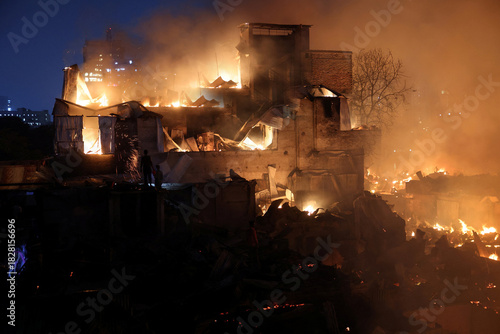 Ancient stone castle engulfed in roaring flames during a dramatic nighttime inferno