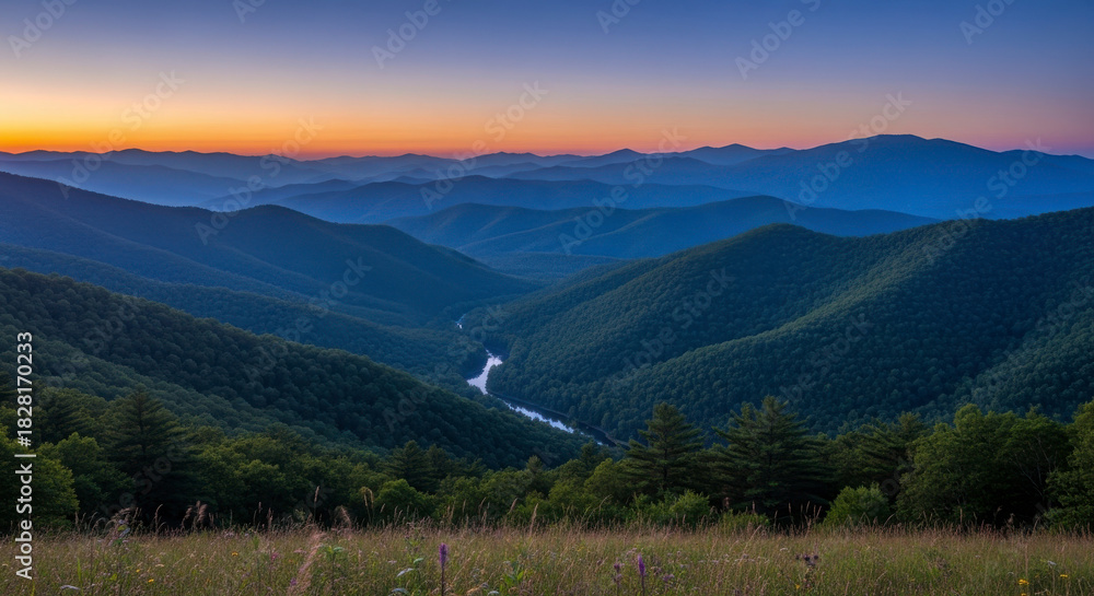 Fototapeta premium Scenic mountain landscape at twilight with a winding river and forested hills