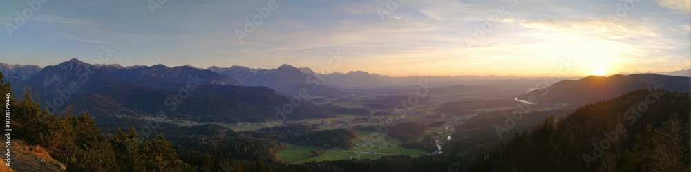 Fototapeta premium Breathtaking mountain valley at sunrise with expansive landscape and distant peaks